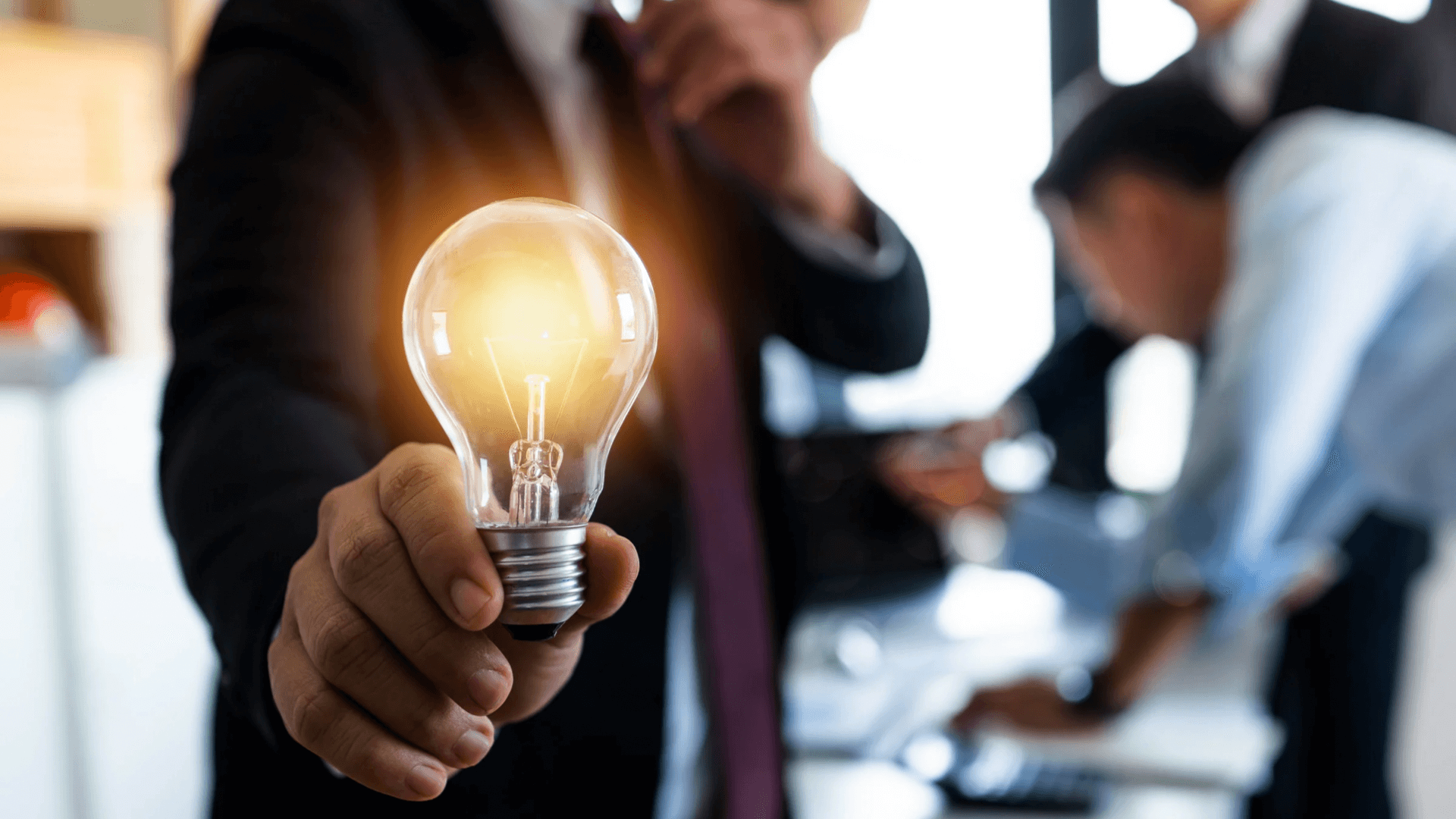 A man holding a bright lightbulb