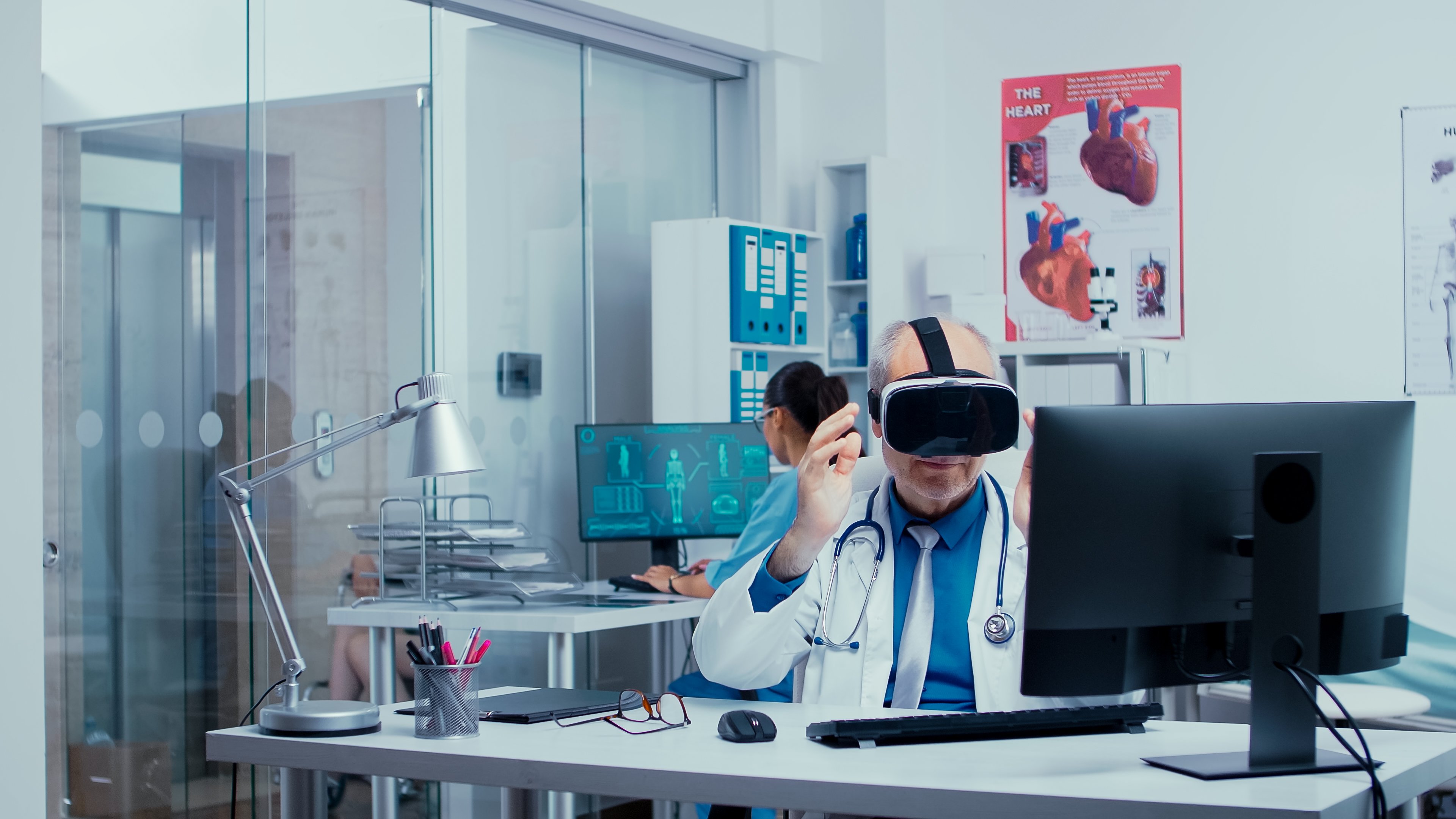 senior-physician-using-vr-glasses-in-modern-privat-RJDDSFB